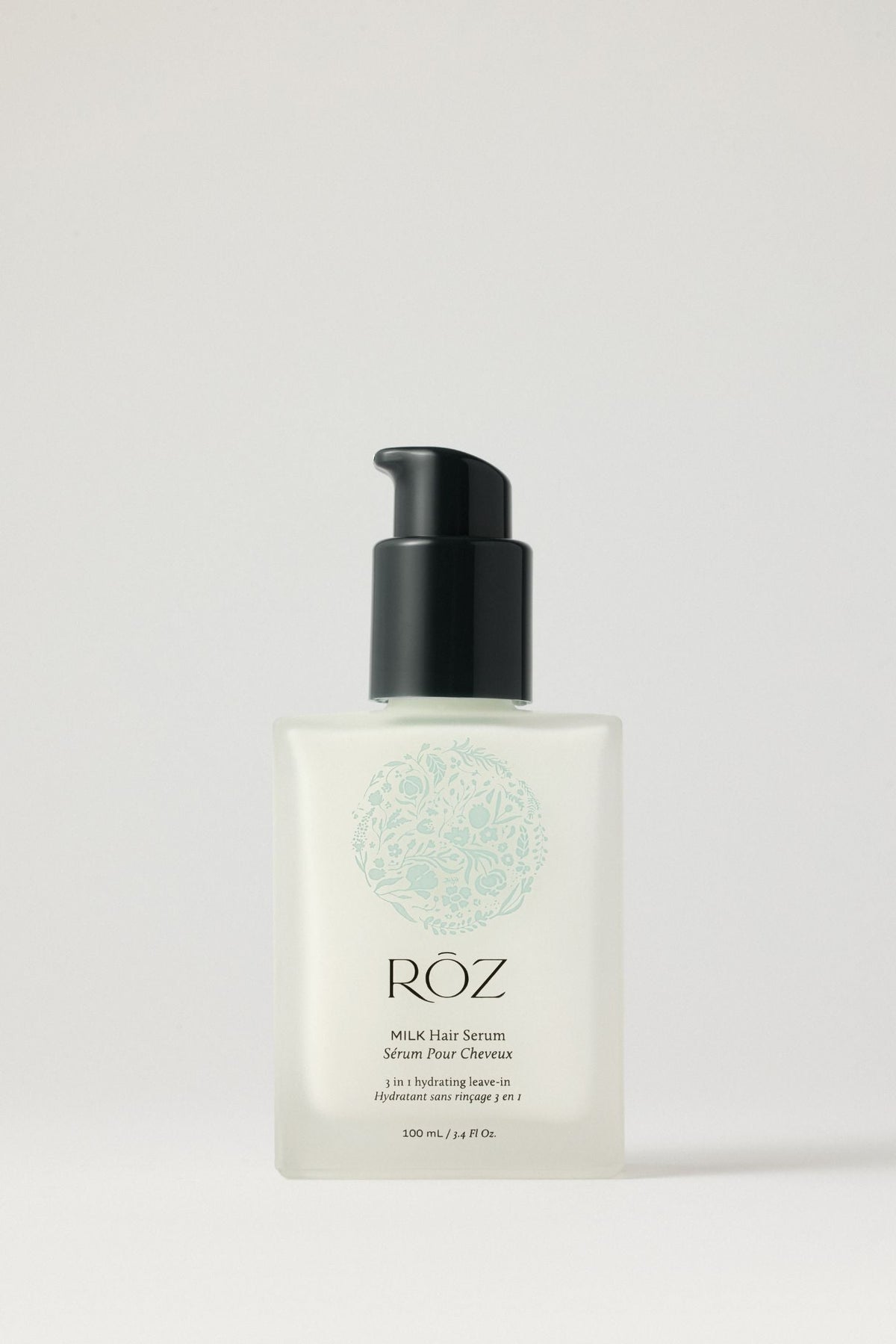 A bottle of RŌZ Milk Hair Serum on a pale background.