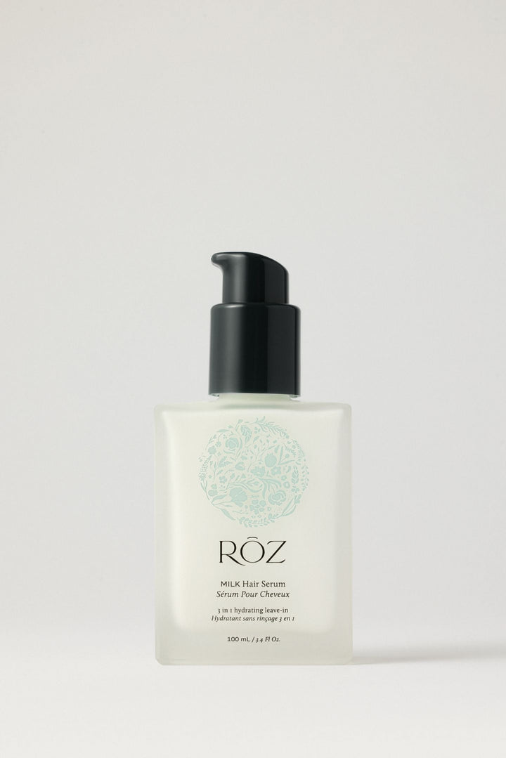 A bottle of RŌZ Milk Hair Serum on a pale background.