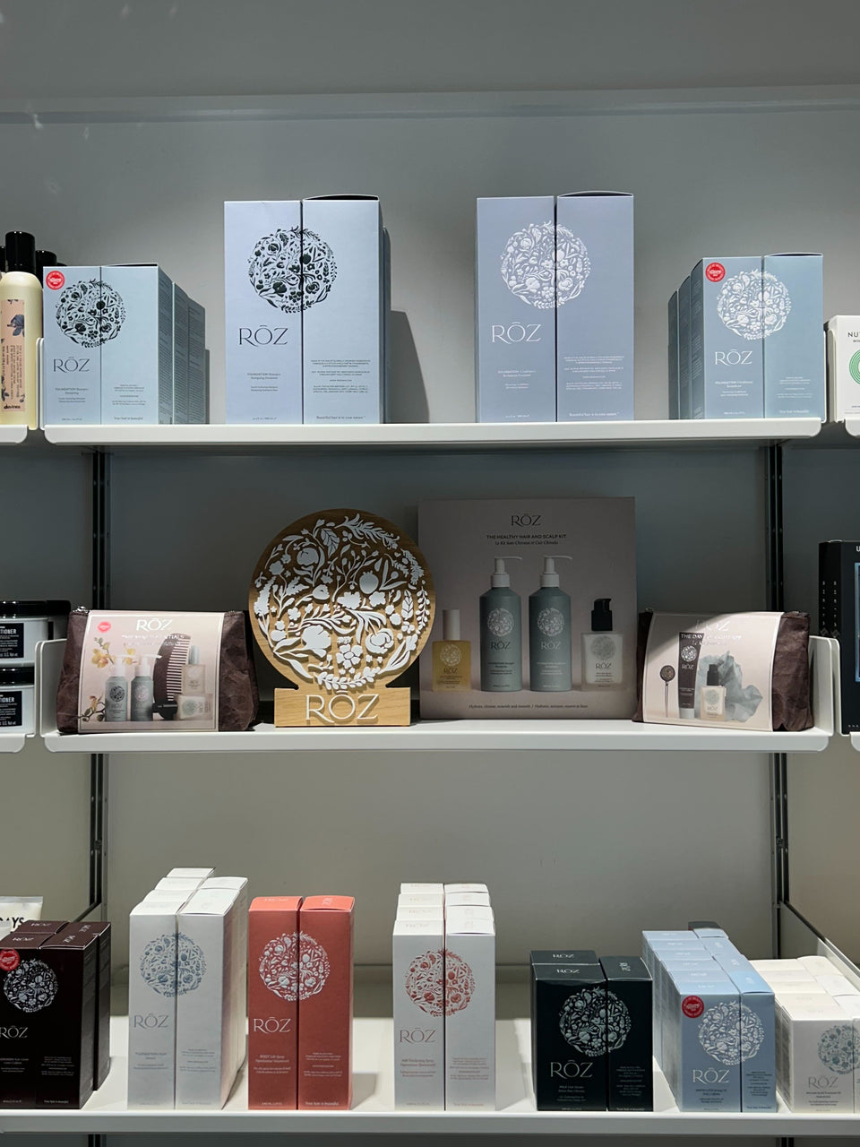 RŌZ haircare products arranged on a salon retail shelf